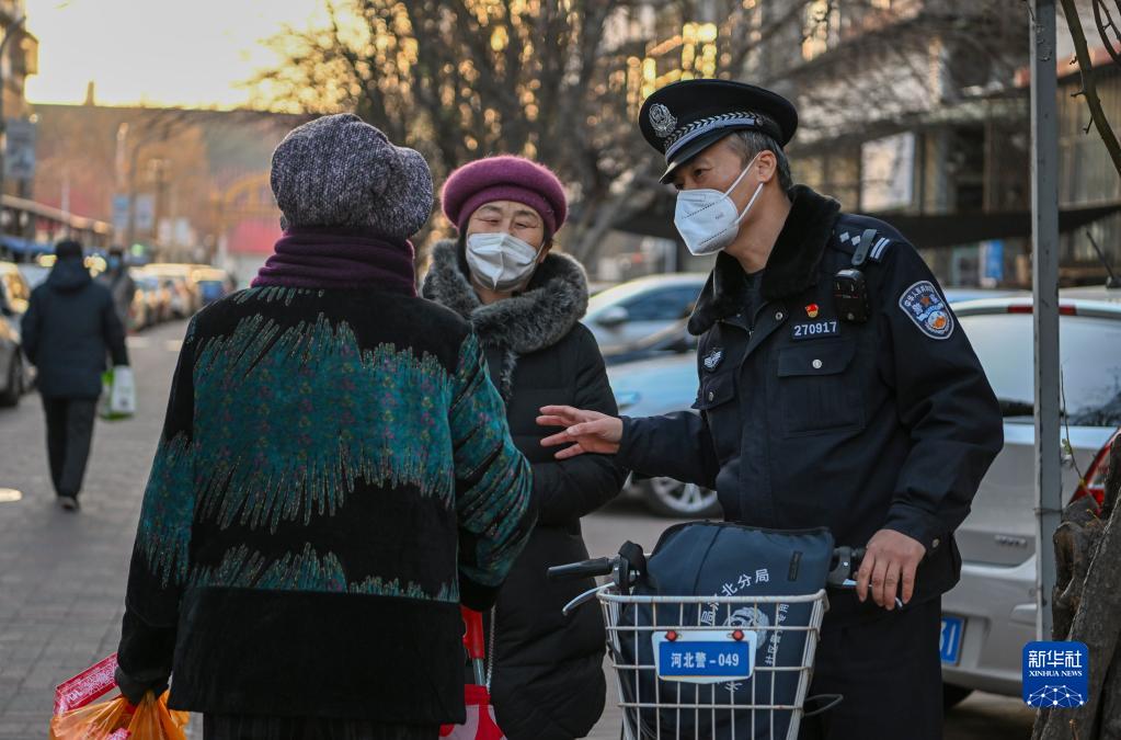 新春走基层丨骑自行车服务社区居民的民警老陈